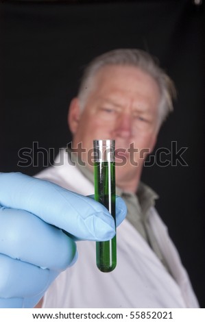chemical engineer, doctor or research scientist holding a sample of a chemical in a test tube