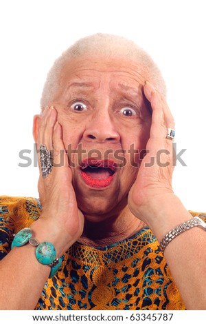 Elderly African American woman in anguish looking shocked, clasping head
