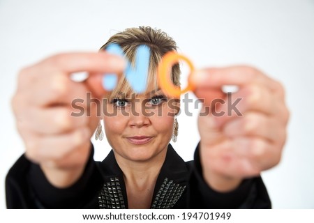 Studio portrait of a cute blond girl holding two letters forming NO