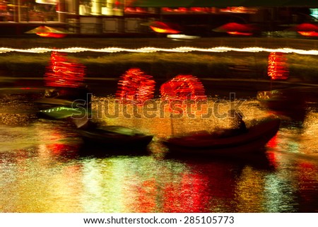Christmas at the Tivoli in Copenhagen at night, boat at low shutter speed