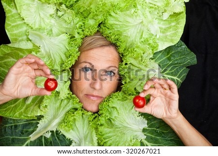 Cute woman with salad leaves arranged around her head.  Can be used for healthy food concept