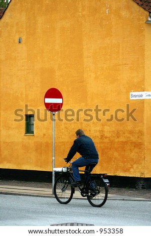 summer in copenhagen in denmark, man on bike houses in copenhagen denmark ancient  buildings, shapes lines etc