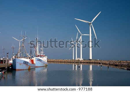 wind mills and fisher boats in a little danish harbour wind mill in denmark a sunny summer day (danish east coast)