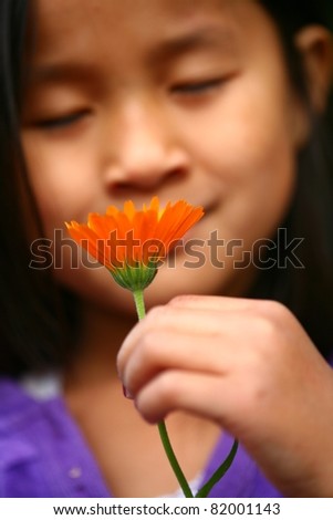 Child smelling a flower