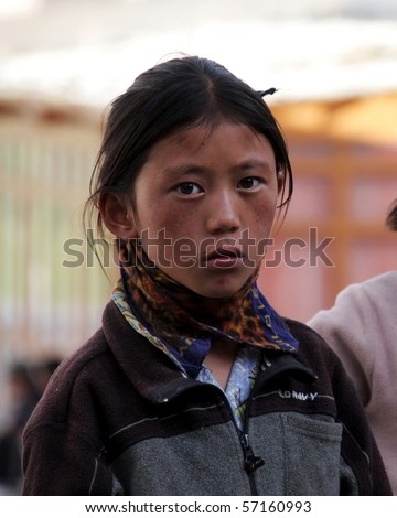 CHOGLAMSAR, INDIA - AUG 15: Unidentified Tibetan girl welcoming tourists in a school on August 15, 2009 in Choglamsar, India. These camps takes care of the education of Tibetan children in exile.