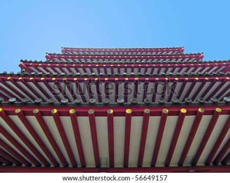 A frog\'s perspective look at a 5-story Japanese pagoda and a blue sky