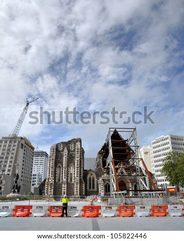 CHRISTCHURCH, NEW ZEALAND - MARCH 10: Panoramic view of the ruins of the Anglican Cathedral on March 10, 2012 in Christchurch. In the background cranes dismantle remaining office blocks in the CBD.