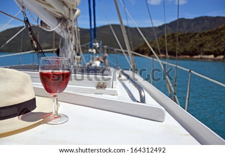 Summer Luxury - a glass of Rose and a Panama hat on the deck of a yacht in the Marlborough Sounds, New Zealand.