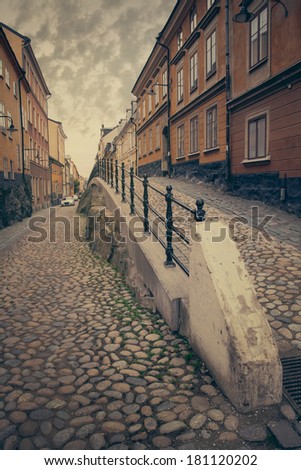 View a narrow street in the Old Town. Stockholm, Sweden. Retro film effect.