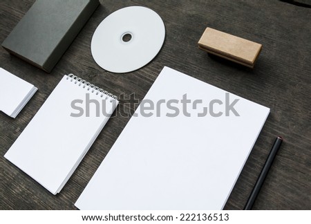 Blank stationery set on old wood background: business cards, booklet, notebook, stamp, CD, and box. Vintage style