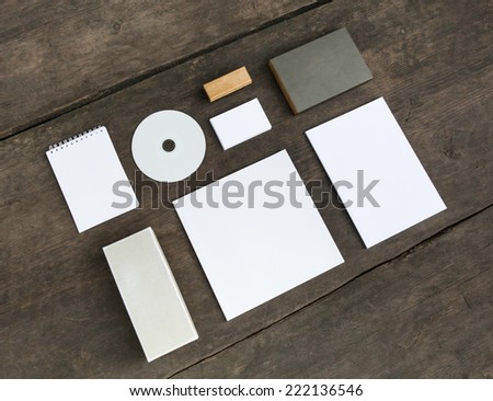 Blank stationery set on old wood background: business cards, booklet, sheets, notebook, stamp, CD, and box. Vintage style