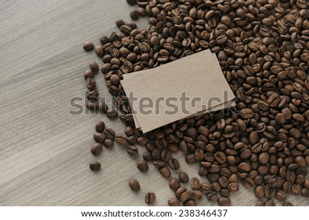 Blank a stack of business cards on coffee beans on a wooden texture