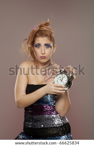 Female model holding clock in hand.. Times up!!