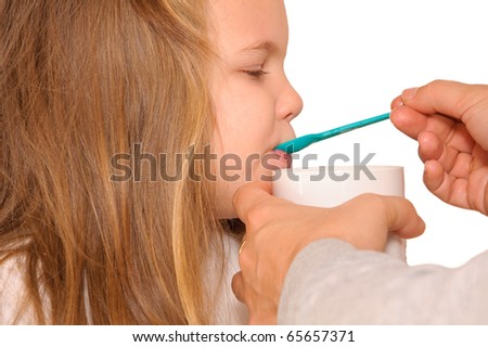 little girl with spoon in her mouth