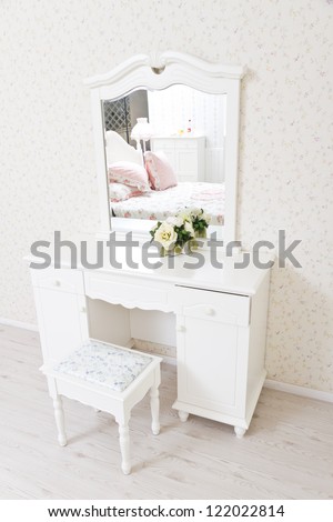 A white dressing table, glass mirror