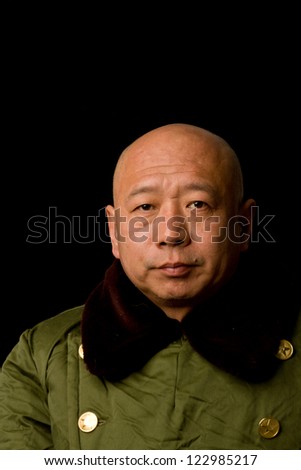 A man dressed in old-fashioned Chinese military uniform