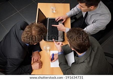 Business people discussing about work at the computer