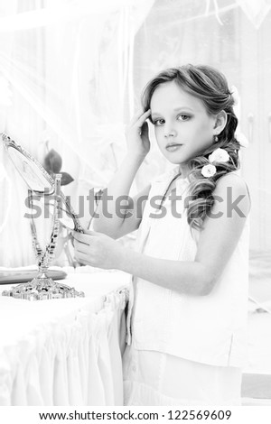 beautiful little girl with mirror looking at you
