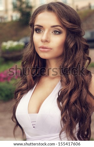 beauty outdoor portrait of young adorable woman with curls