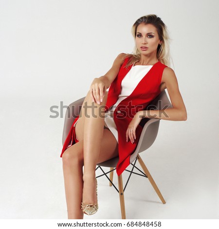 https://image.shutterstock.com/display_pic_with_logo/571009/684848458/stock-photo-young-beautiful-stylish-woman-posing-in-white-short-dress-and-red-jacket-on-bright-gray-background-684848458.jpg
