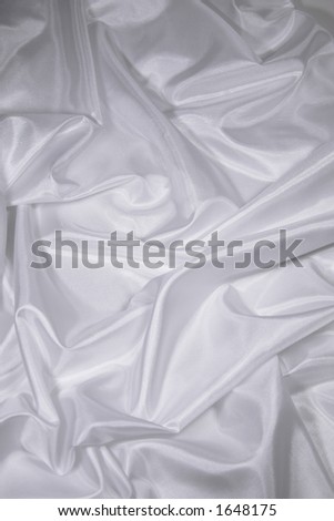 Luxurious white satin/silk folded fabric, useful for backgrounds