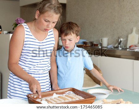 Two kids makes cake in kitchen, indoor