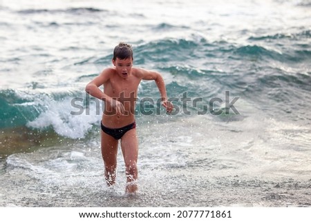 Boy bathes in cold water in the sea in winter, hardening Photo stock © 