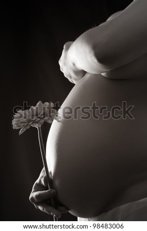Nude pregnancy woman in low light