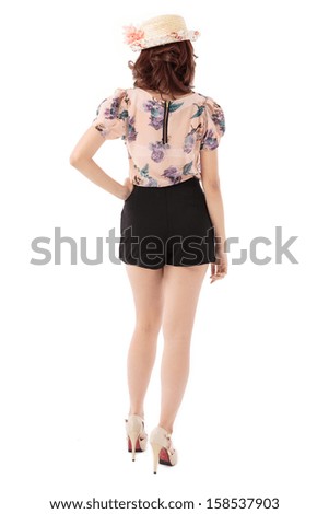 Asian woman full body posing in rosy pastel top and scallop edge skirt shorts with flower top hat isolated on white background.