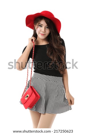 Asian woman full body posing in black cotton top dress and plaid skirt with red hat and shoulder red bag isolated on white background.