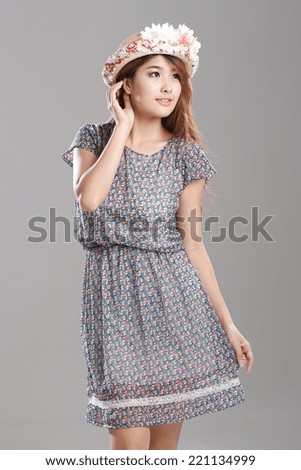 Asian woman posing in 1/2 Sleeve wrapped waist dress with adorable bow print.