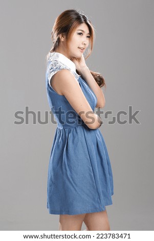 Asian woman in sleeveless white collar denim dress with flare skirt set.