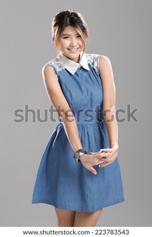 Asian woman in sleeveless white collar denim dress with flare skirt set.