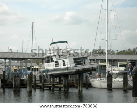 large boat rests on pilings at Lake Pontchartrain marina where it was washed by flood waters of Hurricane Katrina