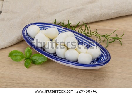 Mozzarella cheese balls in the bowl on desk