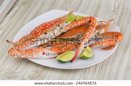Boiled crabs with lime on the wood background
