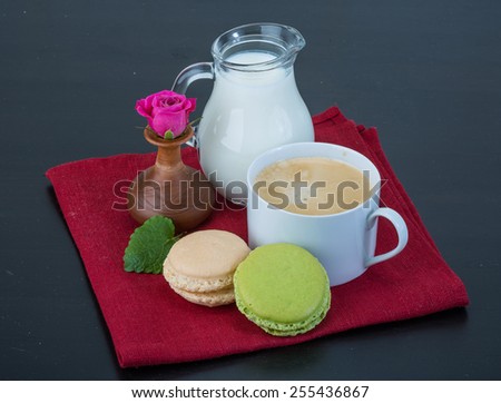 Coffee with macaroons and milk served rose
