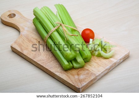 Fresh Green Celery sticks on the wood background