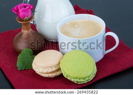 Coffee with macaroons and milk served rose