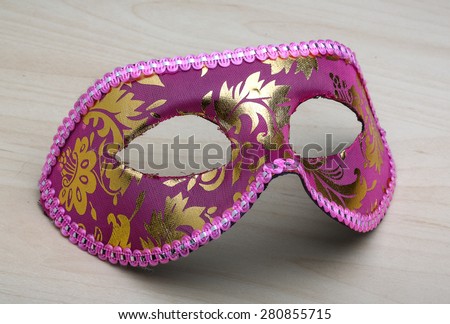 Carnival mask on the wood background