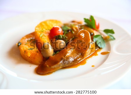 Beef tongue with potato and olives in sauce