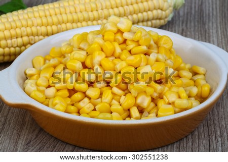Sweet canned fresh corn on the wood background