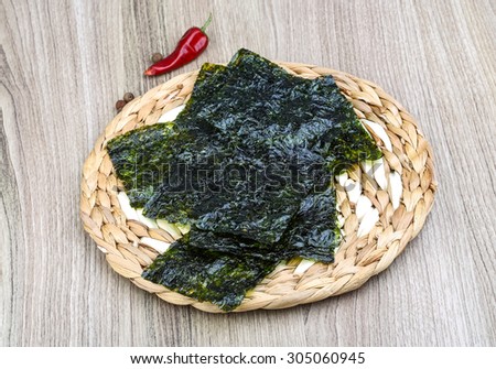 Korean traditional snack - Nori seaweed sheets on the wood background