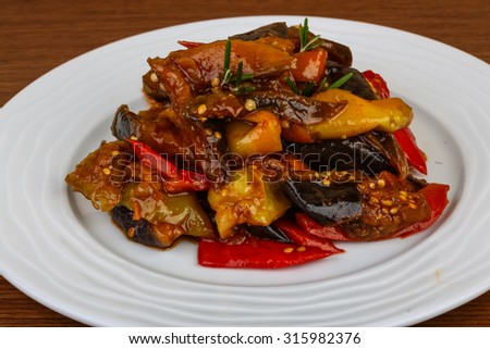 Roasted vegetables with herbs and spices on the wood background