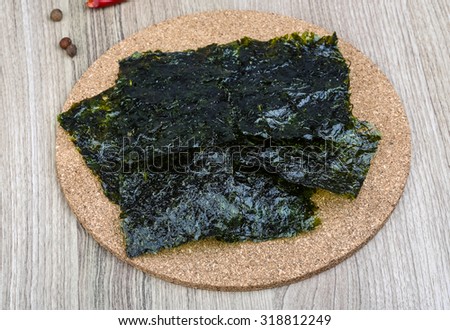 Korean traditional snack - Nori seaweed sheets on the wood background