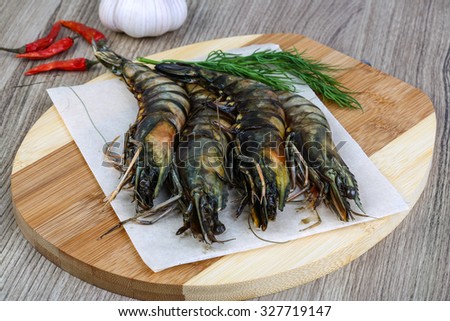 Raw tiger king shrimps ready for cooking with dill