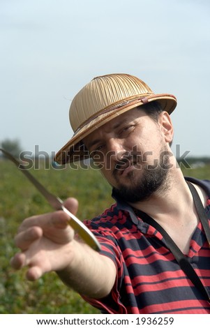 The man painter takes measure. Outdoor portrait with cap and knife. Art, artist.