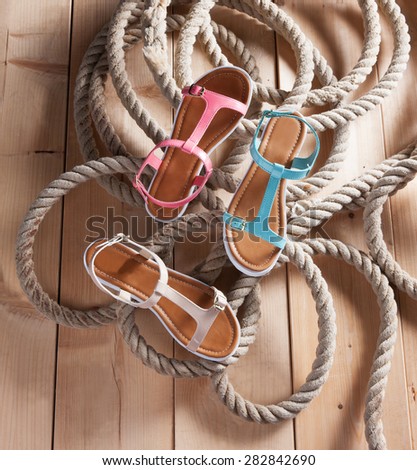 women fins shoes in plan on a deck with a rope