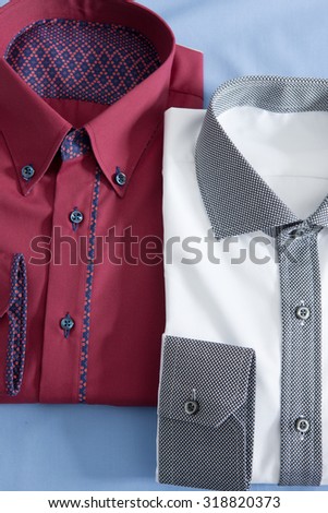 a close up on two folded tshirts on a blue background