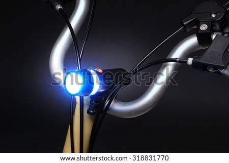 a close up in the light torch on the steering wheel of a bicycle on a studio photo